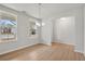 Well-lit dining area featuring wood flooring, large windows and a modern chandelier at 30 Riverrock Trl, Dallas, GA 30157