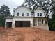 New construction, two-story home with white siding, brick accents, and a two-car garage at 30 Riverrock Trl, Dallas, GA 30157