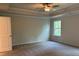 Spacious main bedroom featuring plush carpeting and a ceiling fan for added comfort at 30 Riverrock Trl, Dallas, GA 30157