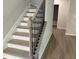 Stylish staircase with gray wood steps and dark iron balusters leading to upper floors at 30 Riverrock Trl, Dallas, GA 30157