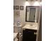 Compact bathroom with a dark wood vanity and coastal themed decorations at 4691 Bo Hendrick Dr, Austell, GA 30106