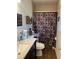 Cozy bathroom with patterned shower curtain, dark cabinets, and nautical themed decor at 4691 Bo Hendrick Dr, Austell, GA 30106