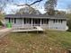 Ranch home with gray exterior, dark roof, and convenient ramp to the front door at 4691 Bo Hendrick Dr, Austell, GA 30106