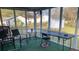 Relaxing screened porch with seating area perfect for enjoying the outdoors at 4691 Bo Hendrick Dr, Austell, GA 30106