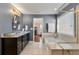View of a bathroom featuring a soaking tub, glass shower, and granite countertop vanity at 4852 Merriman Se Walk # 23, Atlanta, GA 30339