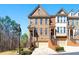 Charming brick townhome featuring a well-manicured lawn, attached garage, and classic architectural details at 4852 Merriman Se Walk # 23, Atlanta, GA 30339
