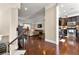 Open-concept foyer with hardwood floors seamlessly leading to a modern kitchen and cozy living room at 4852 Merriman Se Walk # 23, Atlanta, GA 30339