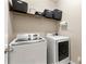 Convenient laundry room featuring modern appliances and ample storage space for organization at 4852 Merriman Se Walk # 23, Atlanta, GA 30339