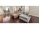 Open-concept living area with hardwood floors, a leather ottoman, and comfortable seating at 4852 Merriman Se Walk # 23, Atlanta, GA 30339
