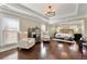 Open main bedroom with sitting area, tray ceiling, and hardwood floors at 4852 Merriman Se Walk # 23, Atlanta, GA 30339