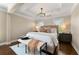 Relaxing main bedroom with a cozy rug, tray ceilings, and ample lighting at 4852 Merriman Se Walk # 23, Atlanta, GA 30339