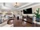 Spacious main bedroom with a sitting area, tray ceilings, and hardwood floors at 4852 Merriman Se Walk # 23, Atlanta, GA 30339
