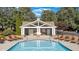 Community pool featuring a covered lounging area and multiple chairs for relaxing by the water at 4852 Merriman Se Walk # 23, Atlanta, GA 30339