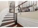 Elegant staircase with hardwood steps, decorative iron railing, and classic white trim details at 4852 Merriman Se Walk # 23, Atlanta, GA 30339