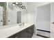 Bathroom with gray vanity with modern countertop sink featuring adjacent room with decorative flooring at 5200 Peachtree Rd # 1111, Atlanta, GA 30341