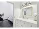 Well-lit bathroom with a white vanity and marble countertop connects to a bedroom with an exercise bike at 5200 Peachtree Rd # 1111, Atlanta, GA 30341