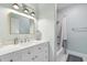Stylish bathroom features a vanity with marble countertop, a shower-tub combo, and modern lighting at 5200 Peachtree Rd # 1111, Atlanta, GA 30341