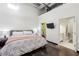 Modern bedroom features a large bed, polished concrete floors, and an attached bathroom for convenience at 5200 Peachtree Rd # 1111, Atlanta, GA 30341