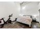 Bright bedroom with a bed, exercise bike, and polished concrete floors, offering space for fitness and relaxation at 5200 Peachtree Rd # 1111, Atlanta, GA 30341