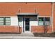 Building entrance with brick facade, covered entrance, and large windows at 5200 Peachtree Rd # 1111, Atlanta, GA 30341