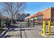 Gated entry to commercial property featuring brick buildings and parking area at 5200 Peachtree Rd # 1111, Atlanta, GA 30341