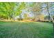 Expansive backyard featuring a well-maintained lawn, mature trees, and a charming deck, perfect for outdoor enjoyment at 895 Tyrell Dr, Austell, GA 30106