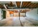 Unfinished basement featuring exposed ceiling and beams and walkout garage doors at 895 Tyrell Dr, Austell, GA 30106