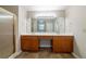 Bathroom with double sinks, wood cabinets, and a shower with glass doors, offering a functional and modern space at 895 Tyrell Dr, Austell, GA 30106