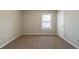 Minimalist bedroom features cozy carpet and a window for natural light, ready for your personal touch at 895 Tyrell Dr, Austell, GA 30106