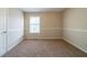 Well-lit bedroom with soft carpet, neutral paint, and a window that offers ample natural light at 895 Tyrell Dr, Austell, GA 30106
