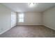 Bedroom featuring neutral walls, plush carpet, and a window at 895 Tyrell Dr, Austell, GA 30106