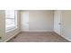 Clean bedroom with neutral colors, carpeted floor, and a window, offering a calming and adaptable space at 895 Tyrell Dr, Austell, GA 30106