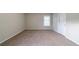 Bedroom featuring neutral walls, plush carpet, and a window at 895 Tyrell Dr, Austell, GA 30106
