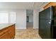 Bright kitchen with wood cabinetry and a view of the living room through doorway at 895 Tyrell Dr, Austell, GA 30106