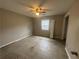 Bedroom with fan and window, awaiting flooring and personalization at 1430 Country Lane Ne Dr, Conyers, GA 30012