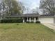 Charming single-story home featuring a well-maintained lawn and an attached two-car garage at 1430 Country Lane Ne Dr, Conyers, GA 30012