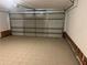 Spacious garage with light tiled floors, exposed drywall, and a white sectional garage door at 1430 Country Lane Ne Dr, Conyers, GA 30012