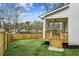 Manicured backyard with a wooden fence, covered deck, and manicured lawn at 1967 Nash Se Ave, Atlanta, GA 30316
