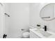 Modern bathroom with a round mirror, matte black fixtures, and sleek vanity at 1967 Nash Se Ave, Atlanta, GA 30316