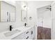 Bathroom featuring double sinks, white cabinets, and black hardware, with an open doorway to the bedroom at 1967 Nash Se Ave, Atlanta, GA 30316