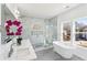 Bright and modern bathroom features double vanity, soaking tub, and walk-in shower with marble surround at 1967 Nash Se Ave, Atlanta, GA 30316