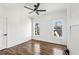 Bedroom with hardwood floors, white walls, ceiling fan, and natural light from two windows at 1967 Nash Se Ave, Atlanta, GA 30316