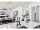 This kitchen offers pendant lighting, island with sink, dining table, and stairs at 1967 Nash Se Ave, Atlanta, GA 30316