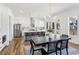 Open-concept kitchen and dining area with white cabinets and stainless steel appliances at 1967 Nash Se Ave, Atlanta, GA 30316