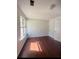 Cozy bedroom with hardwood floors and a large window providing natural light at 2575 Picardy N Cir # B, Atlanta, GA 30349