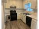 Functional kitchen featuring updated countertops, wood cabinets, and modern appliances at 2575 Picardy N Cir # B, Atlanta, GA 30349