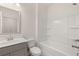 Bright bathroom features a white vanity with a framed mirror, and a clean, white shower-tub combo at 13912 Homer, Covington, GA 30014