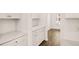 Kitchen with white cabinets and tile backsplash leads to a light-filled dining area at 13912 Homer, Covington, GA 30014