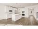 The spacious kitchen boasts white cabinetry, stainless appliances, and beautiful hardwood floors at 13912 Homer, Covington, GA 30014