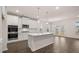 A modern kitchen features white cabinets, stainless appliances, and a center island at 13912 Homer, Covington, GA 30014